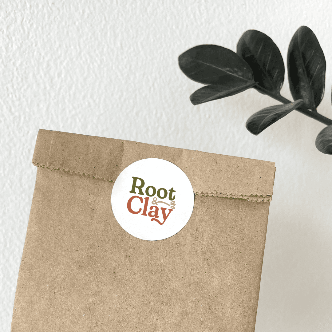 Paper bag with Root & Clay logo.